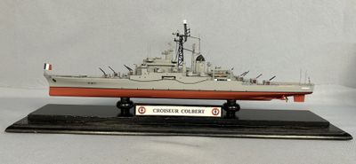 a model of a ship on a stand on a white surface