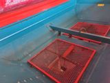 a red and blue boat with a red seat on it