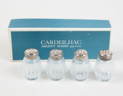 three salt and pepper shakers in a box with a box behind them