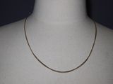 a close up of a mannequin torso with a chain on it