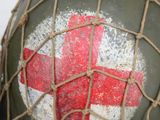 a close up of a helmet with a red cross painted on it