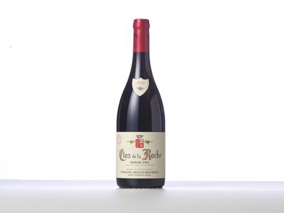 a bottle of red wine sitting on top of a table