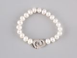 a white pearl bracelet with a silver heart charm