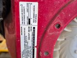 a close up of a red and black engine on a pallet