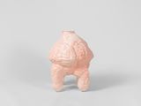 pink ceramic figurine of a teddy bear on a white background