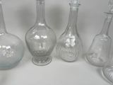 five glass vases sitting next to each other on a table