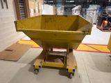 a large yellow dumpster sitting in the middle of a warehouse