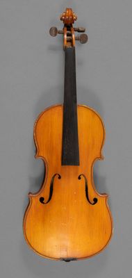 an old violin with a wooden back and bow on a gray background