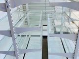 a glass display case that has a lot of shelves in it