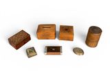 several small wooden objects are arranged on a white surface