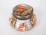 a small box with a painting on it sitting on a table