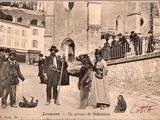an old photo of a group of people on the street