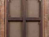 an old window with a wooden frame on the outside of it