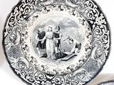 three black and white plates with a picture of a man and a woman on them