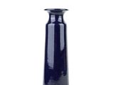 a blue vase that is sitting on a white surface