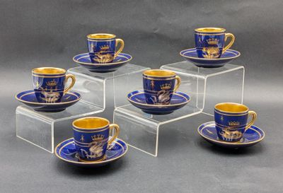 six cups and saucers with blue and gold designs on them