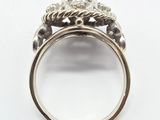a close up view of a silver ring with a flower design on it