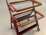 three tiered glass and wood serving cart on wheels on a white surface