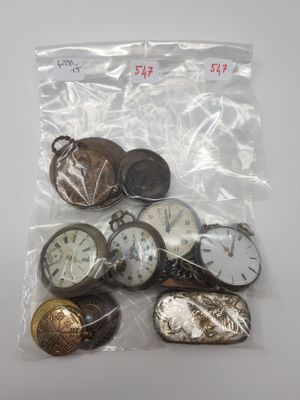 a bag of assorted pocket watches on a table