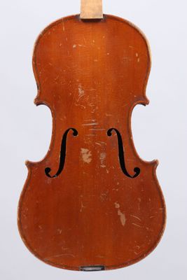 an old violin sitting on top of a wooden stand