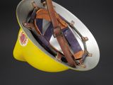 a yellow helmet with a leather strap on it