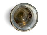 overhead view of a glass of water on a white surface