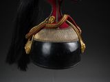 a close up of a helmet on a stand on a black background