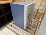 a blue and white refrigerator sitting on a pallet in a room