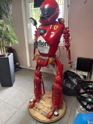 un robot rouge qui se tient debout sur une plate-forme en bois
