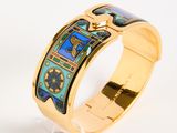 an image of a gold bracelet with a clock on it
