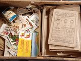 a box full of books and papers on the floor