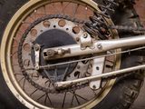 a close up of a motorcycle tire with a chain on it