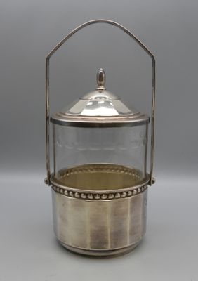 an antique silver plated teapot with a glass lid