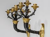 une image représentant un lustre doré et noir orné d'oiseaux