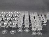 a lot of wine glasses and a vase on the table