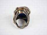 an image of a silver ring with a blue stone in it