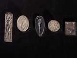 five different types of silver and silver jewelry on a black surface
