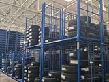 a large warehouse filled with lots of tires and shelves