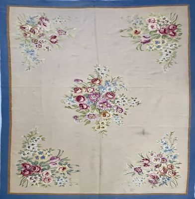 a close up of a blue and white rug with flowers on it