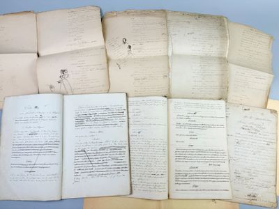 several old papers are stacked on top of each other on a table
