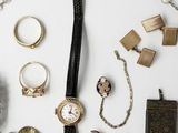 many different types of jewelry on a white surface