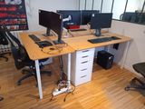 a desk with two monitors and a keyboard on it