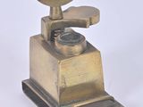 a small metal grinder with a wooden handle