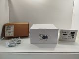 a white box sitting on top of a white table next to a box