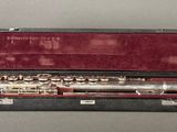 a flute that is in a case on a table