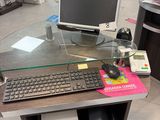 a computer desk with a keyboard and a monitor on it