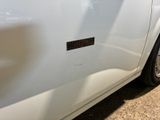 a close up of a white car with a sticker on it