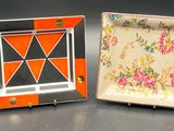two small plates with designs on them sitting on a table