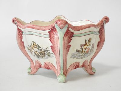 a pink and green planter with a horse and carriage design