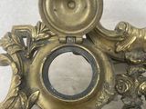 a gold clock with a bird on top of it